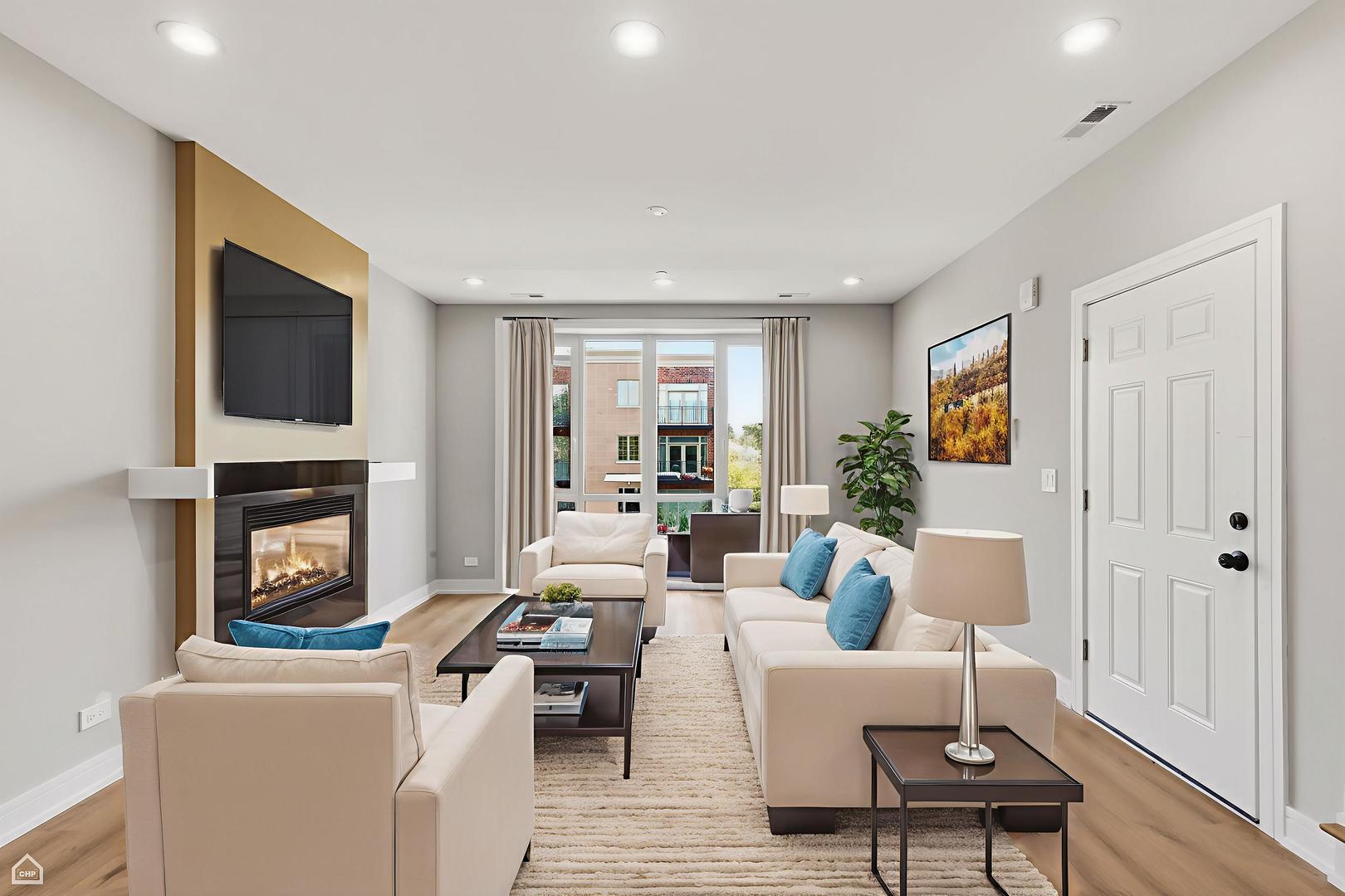 2718 Budd Street, Unit 2N River Grove, IL 60171 - Photo 9 of 48 a living room with furniture a fireplace and a flat screen tv