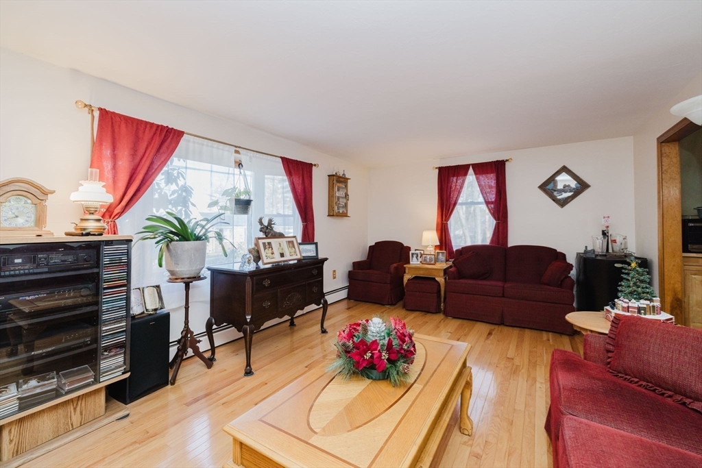 36 Indian Run Road Bellingham, MA 02019 - Photo 11 of 33 a living room with furniture and a floor to ceiling window