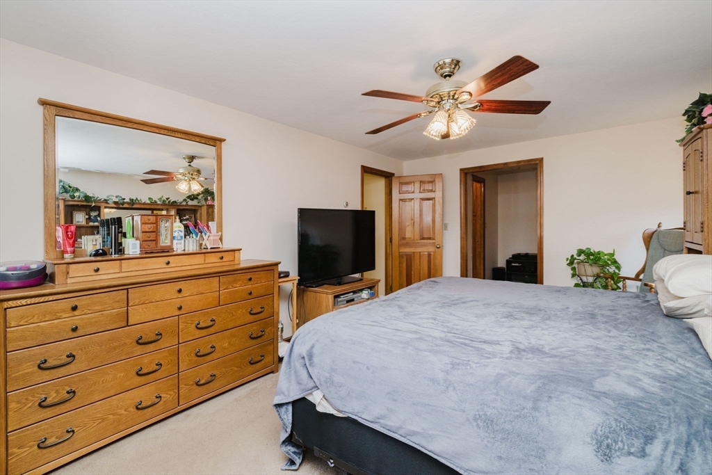 36 Indian Run Road Bellingham, MA 02019 - Photo 15 of 25 a bedroom with a bed and a flat screen tv on dresser