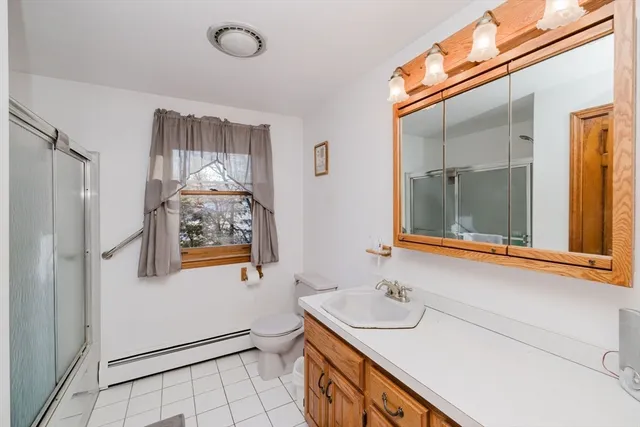 a bathroom with a shower and a sink