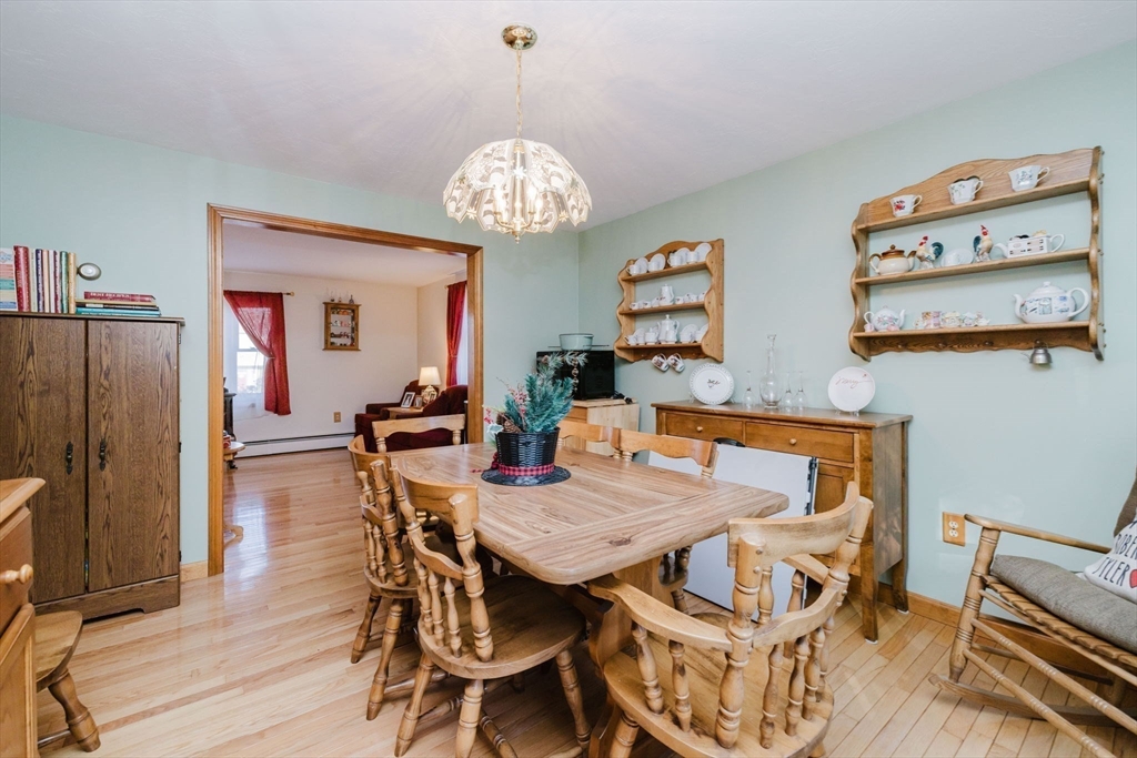 36 Indian Run Road Bellingham, MA 02019 - Photo 10 of 33 a view of a dining room with furniture a chandelier and wooden floor