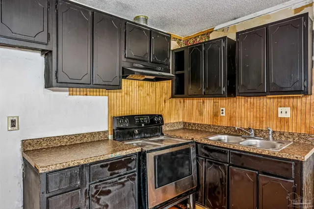 a kitchen with a stove and a sink