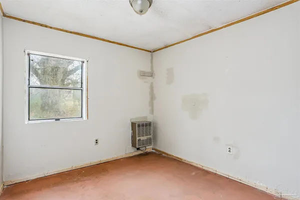 a view of a room with rack on the wall and a window