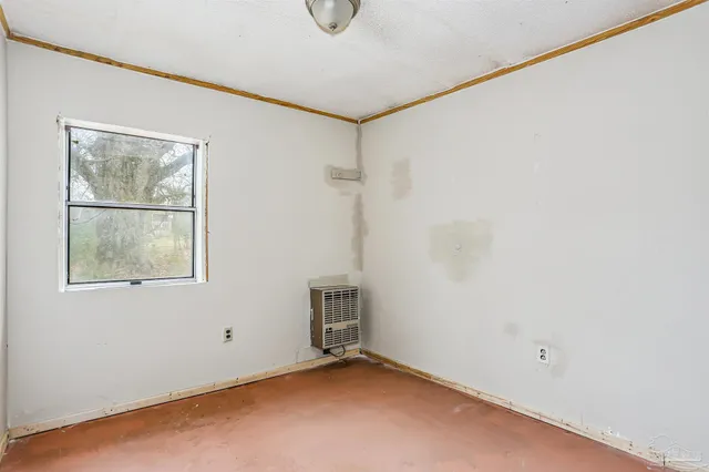 a view of a room with rack on the wall and a window