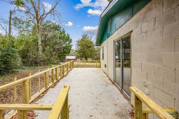 a view of balcony with wooden floor and fence