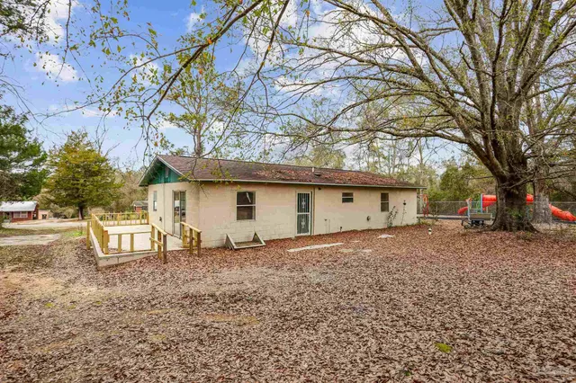 a house that has a tree in front of it