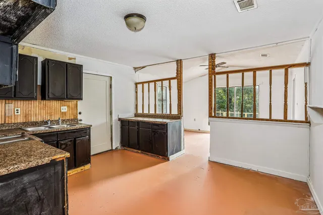 a kitchen with a stove a sink and a refrigerator