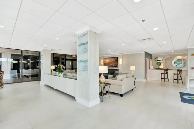 a view of a hallway with dining area and glass door