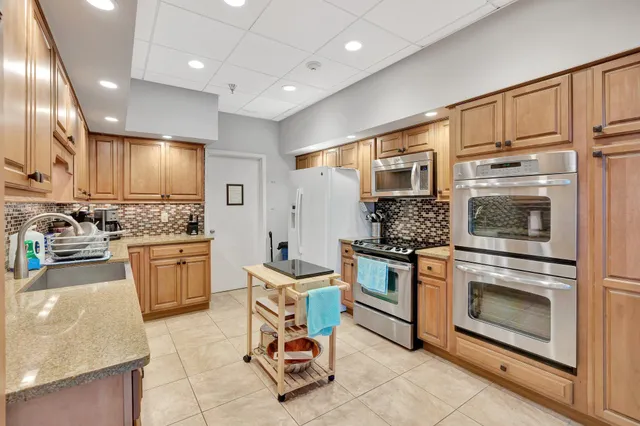a room with gym equipment and wooden floor
