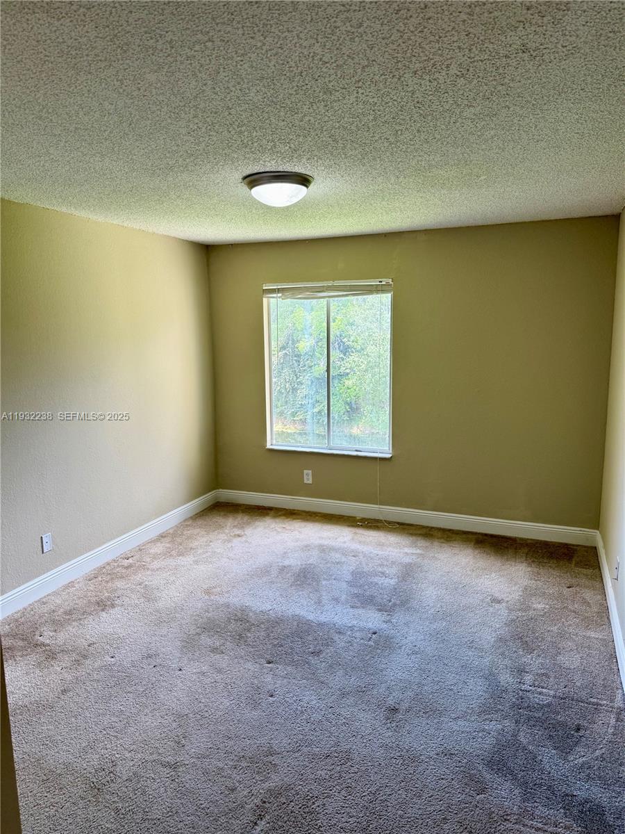 595 Vista Isles Drive, Unit 1923 Sunrise, FL 33325 - Photo 13 of 18 an empty room with a empty space and a window