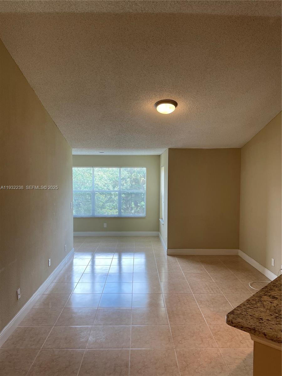 595 Vista Isles Drive, Unit 1923 Sunrise, FL 33325 - Photo 2 of 18 an empty room with windows