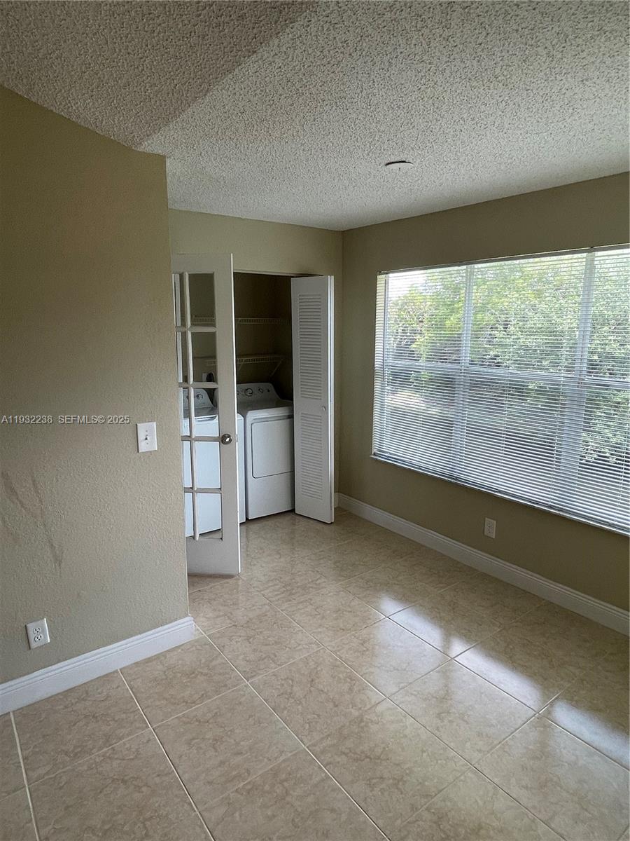 595 Vista Isles Drive, Unit 1923 Sunrise, FL 33325 - Photo 10 of 18 an empty room with windows and view