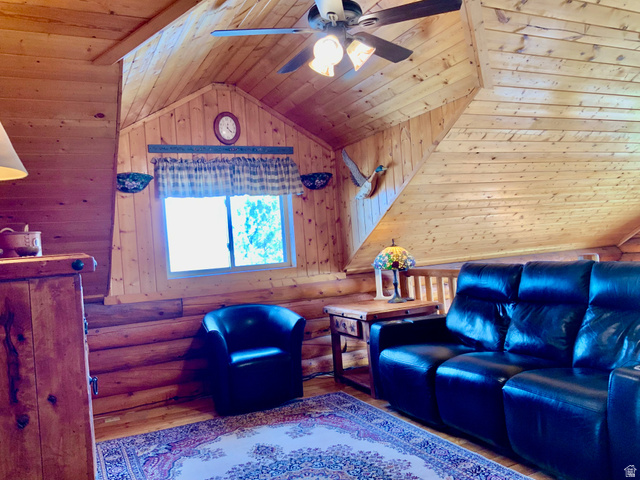 76 Highway 118 Monroe, UT 84754 - Photo 46 of 76 Living room with wood ceiling, vaulted ceiling, wood finished floors, log walls, and wooden walls