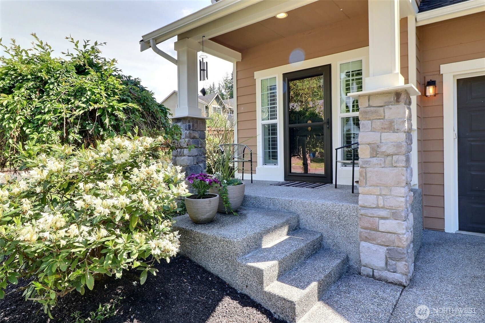 19776 Mountain Ridge Road Southeast Monroe, WA 98272 - Photo 2 of 40 a view of a porch with chairs and potted plants