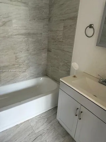 a bathroom with a bathtub and a sink