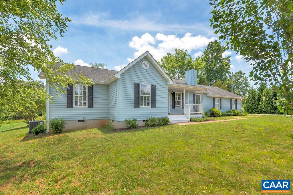231 Angie Place Ruckersville, VA 22968 - Photo 4 of 37 a front view of a house with a garden and yard