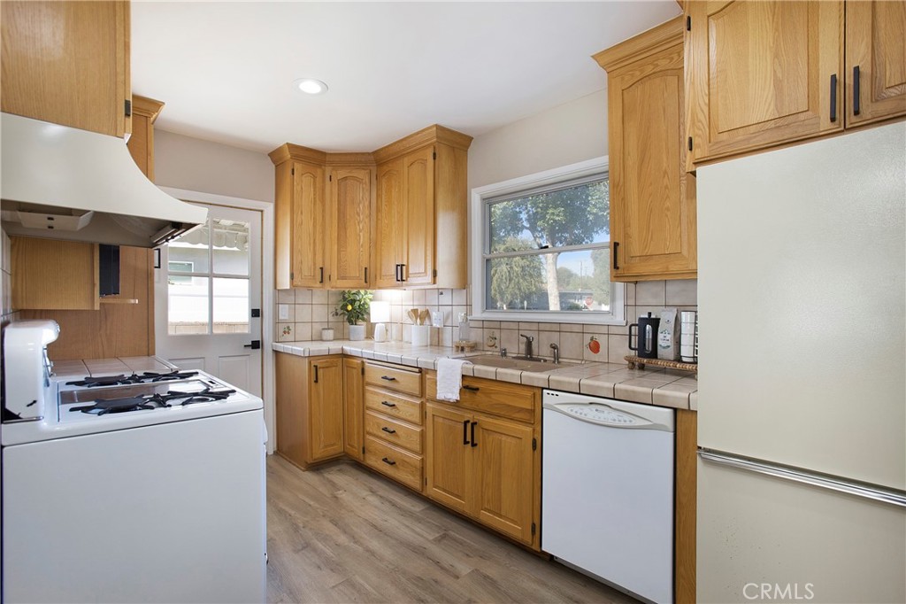 708 East Alder Street Brea, CA 92821 - Photo 9 of 34 a kitchen with stainless steel appliances a sink stove and cabinets