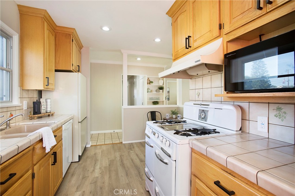 708 East Alder Street Brea, CA 92821 - Photo 10 of 34 a kitchen with a stove a sink and a refrigerator