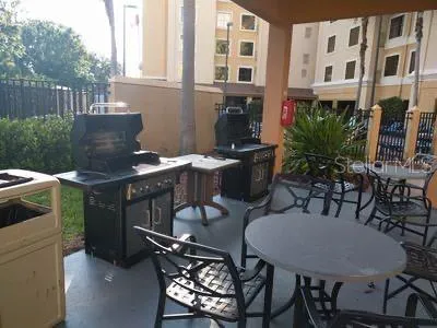 a view of a patio with table and chairs and potted plants