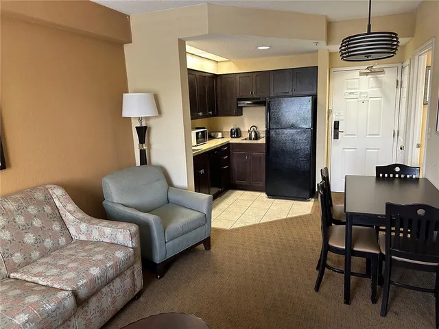 a living room with furniture and a lamp