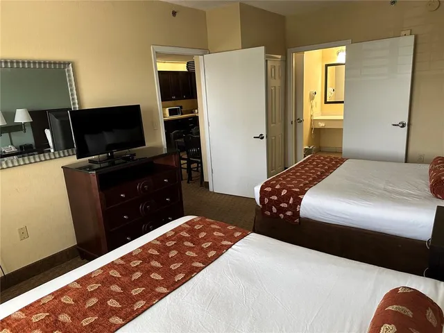 a bedroom with a bed and flat screen tv