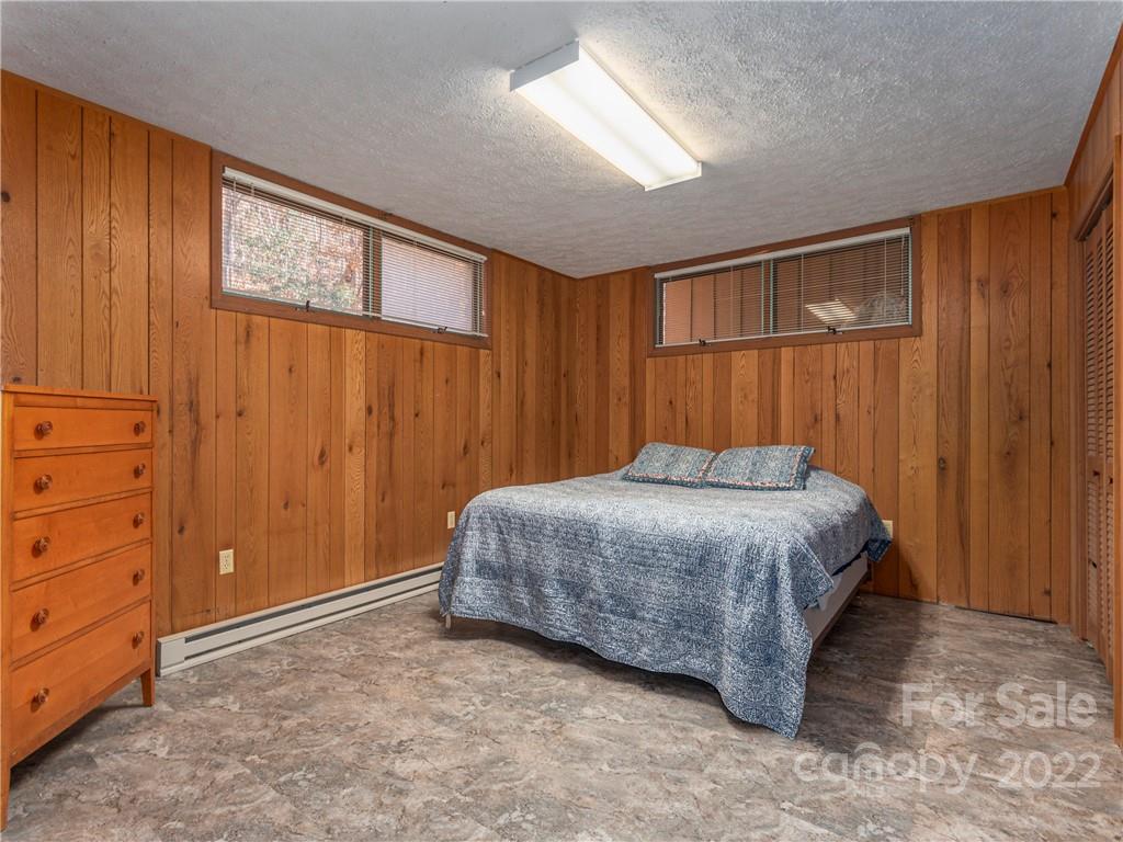 634 Big Stomp Road Waynesville, NC 28786 - Photo 22 of 29 a bedroom with a bed and cabinets