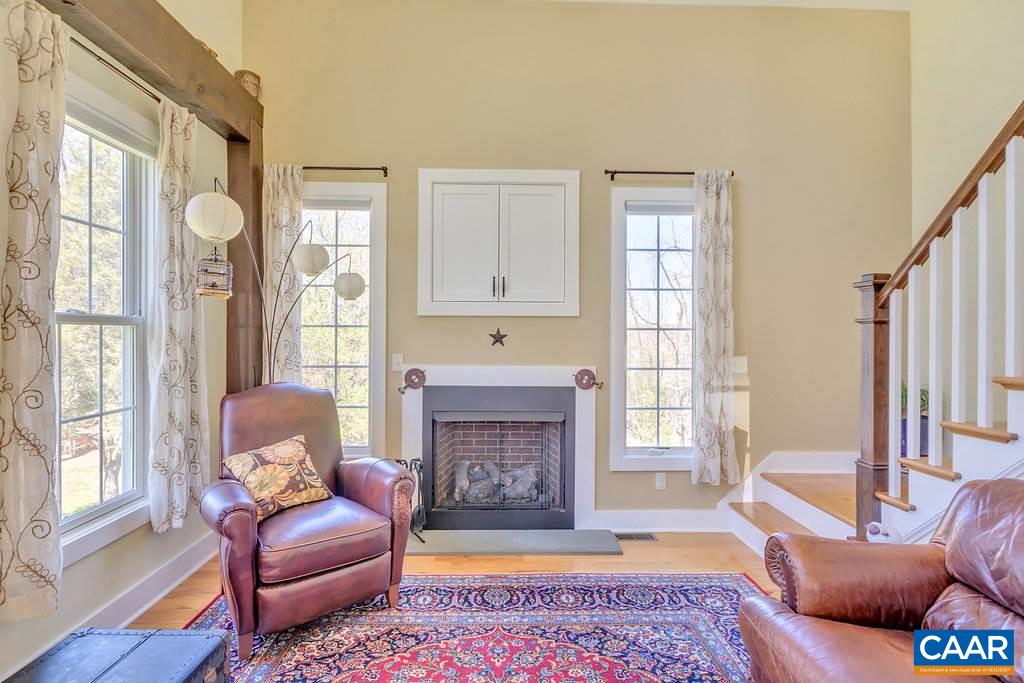 85 Fox Ridge Lane Ruckersville, VA 22968 - Photo 7 of 33 a living room with furniture a rug a fireplace and windows