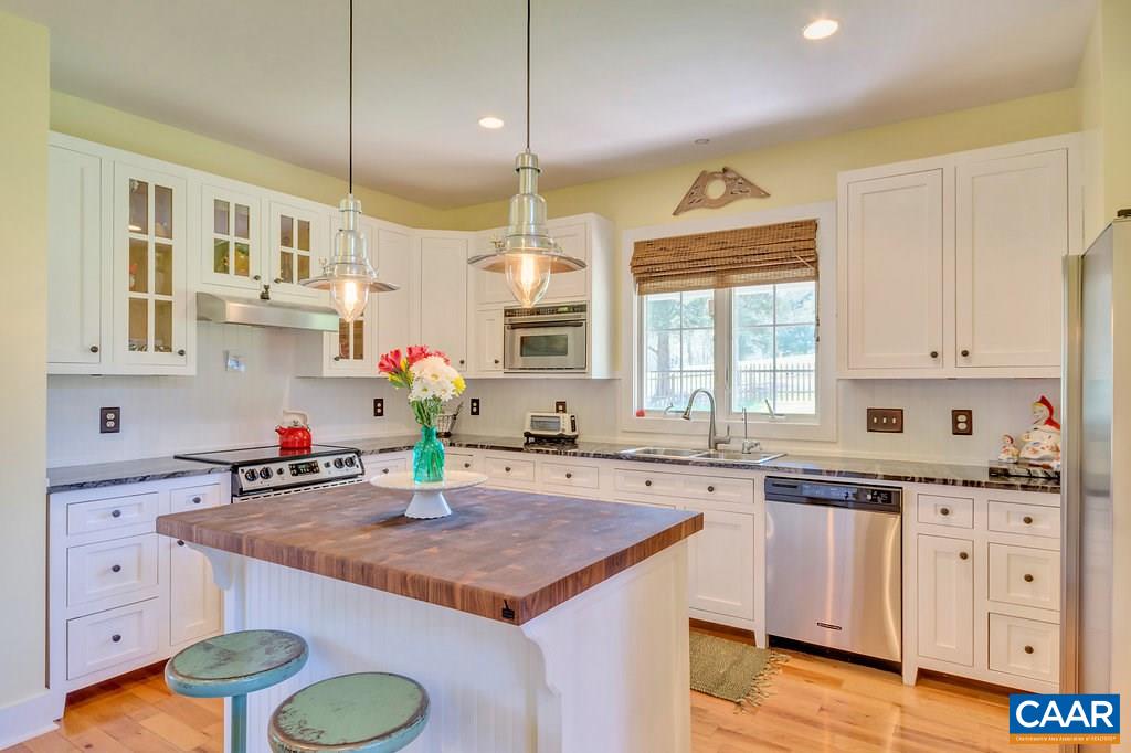 85 Fox Ridge Lane Ruckersville, VA 22968 - Photo 8 of 33 a kitchen with kitchen island granite countertop a sink cabinets and wooden floor