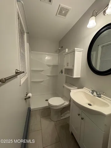 a bathroom with a sink toilet and a mirror