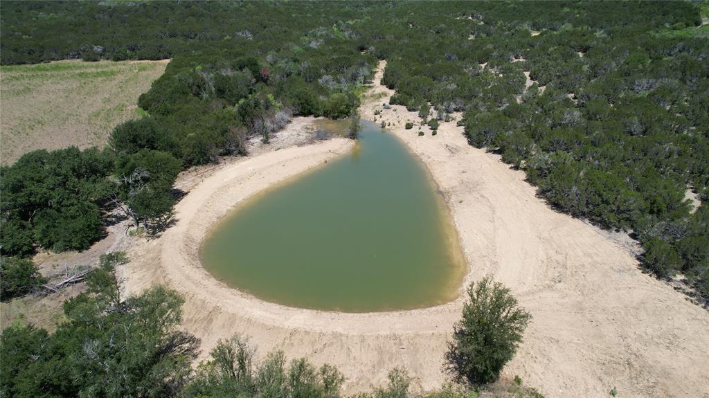 464 Upper Brad Road Strawn, TX 76475 - Photo 16 of 32 a view of a swimming pool with a yard