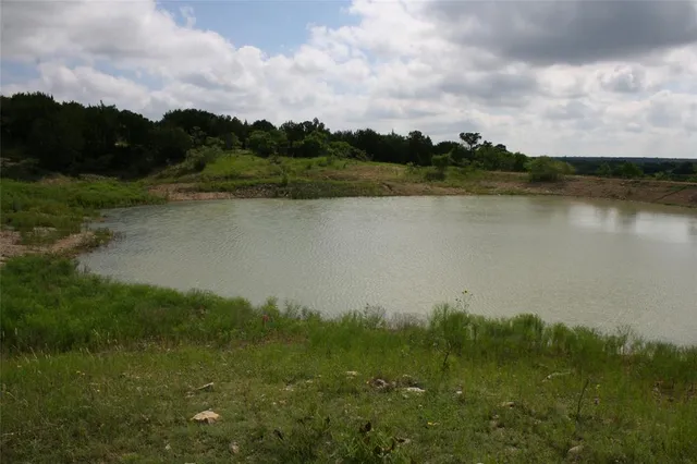 a view of a lake with houses in the back