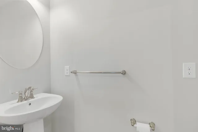 a bathroom with a sink and mirror