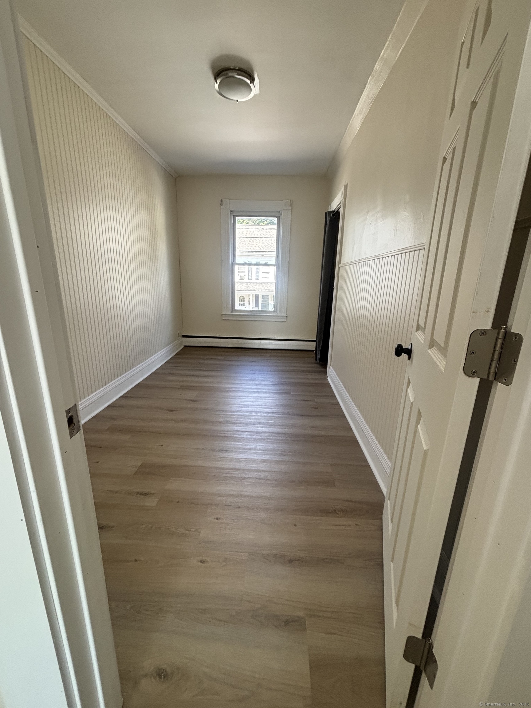 161 Cliff Street Norwich, CT 06360 - Photo 12 of 14 wooden floor in an empty room with a window