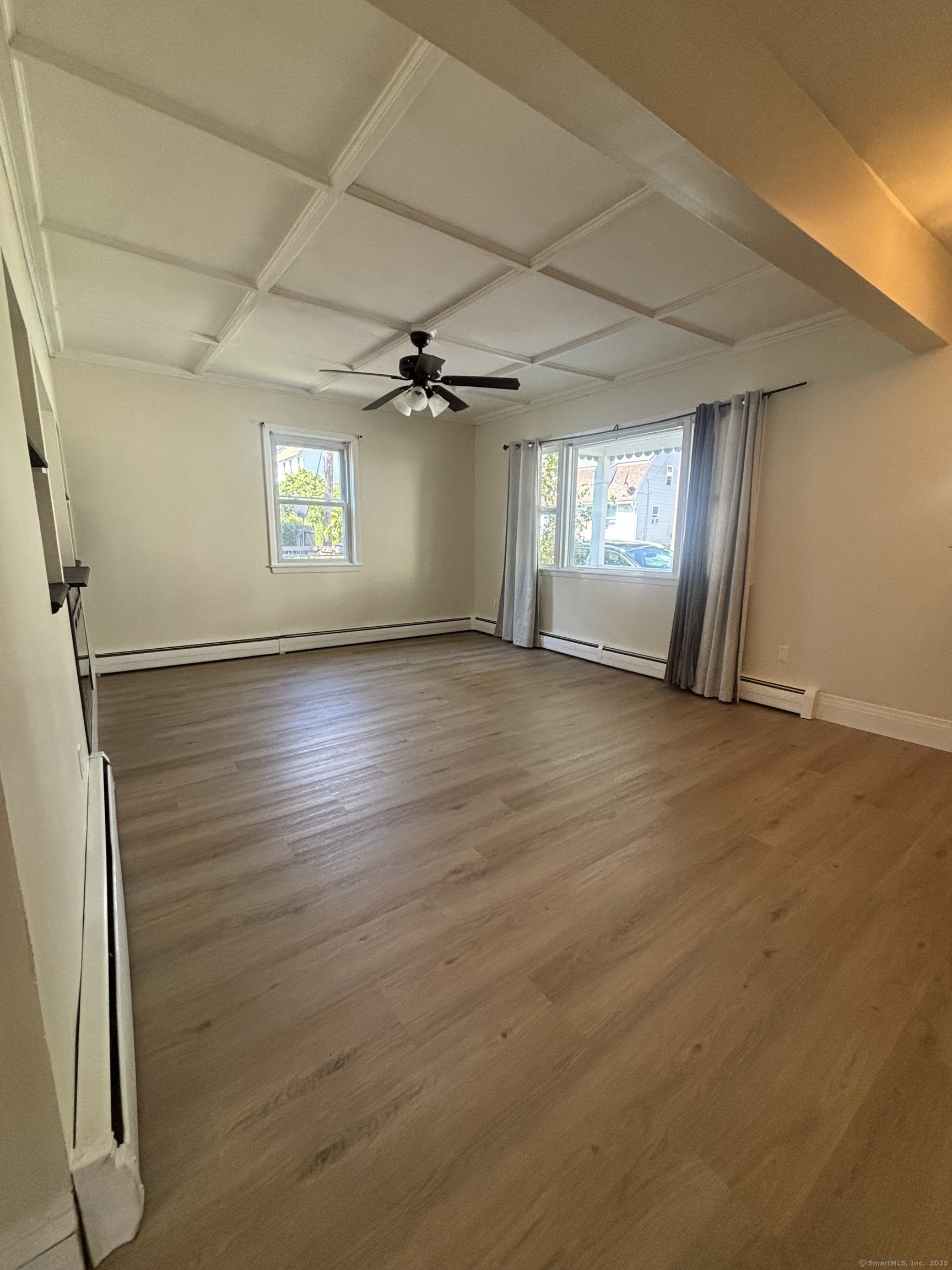 161 Cliff Street Norwich, CT 06360 - Photo 2 of 14 an empty room with wooden floor and windows