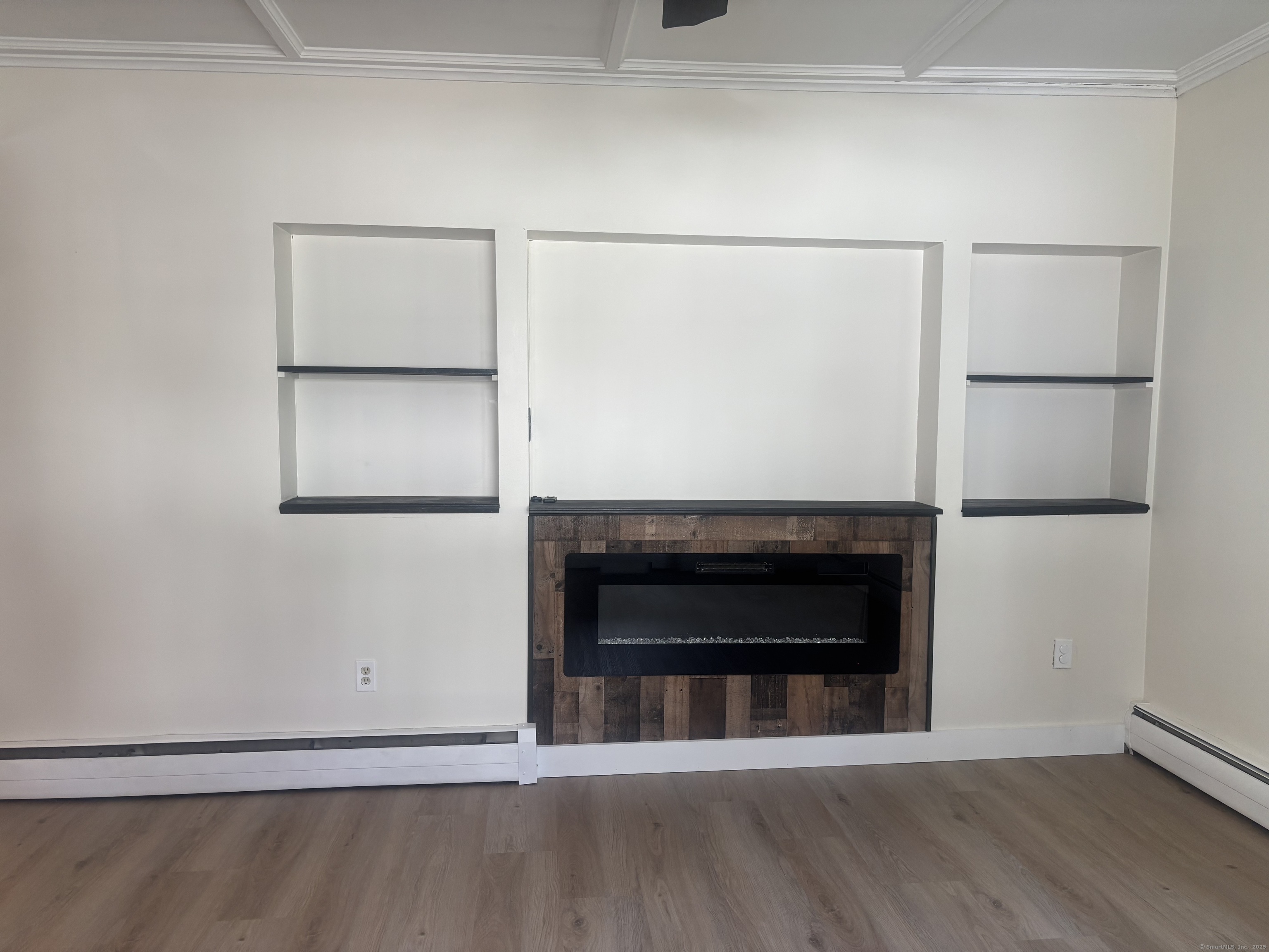 161 Cliff Street Norwich, CT 06360 - Photo 3 of 14 a living room with a empty shelf and a fireplace