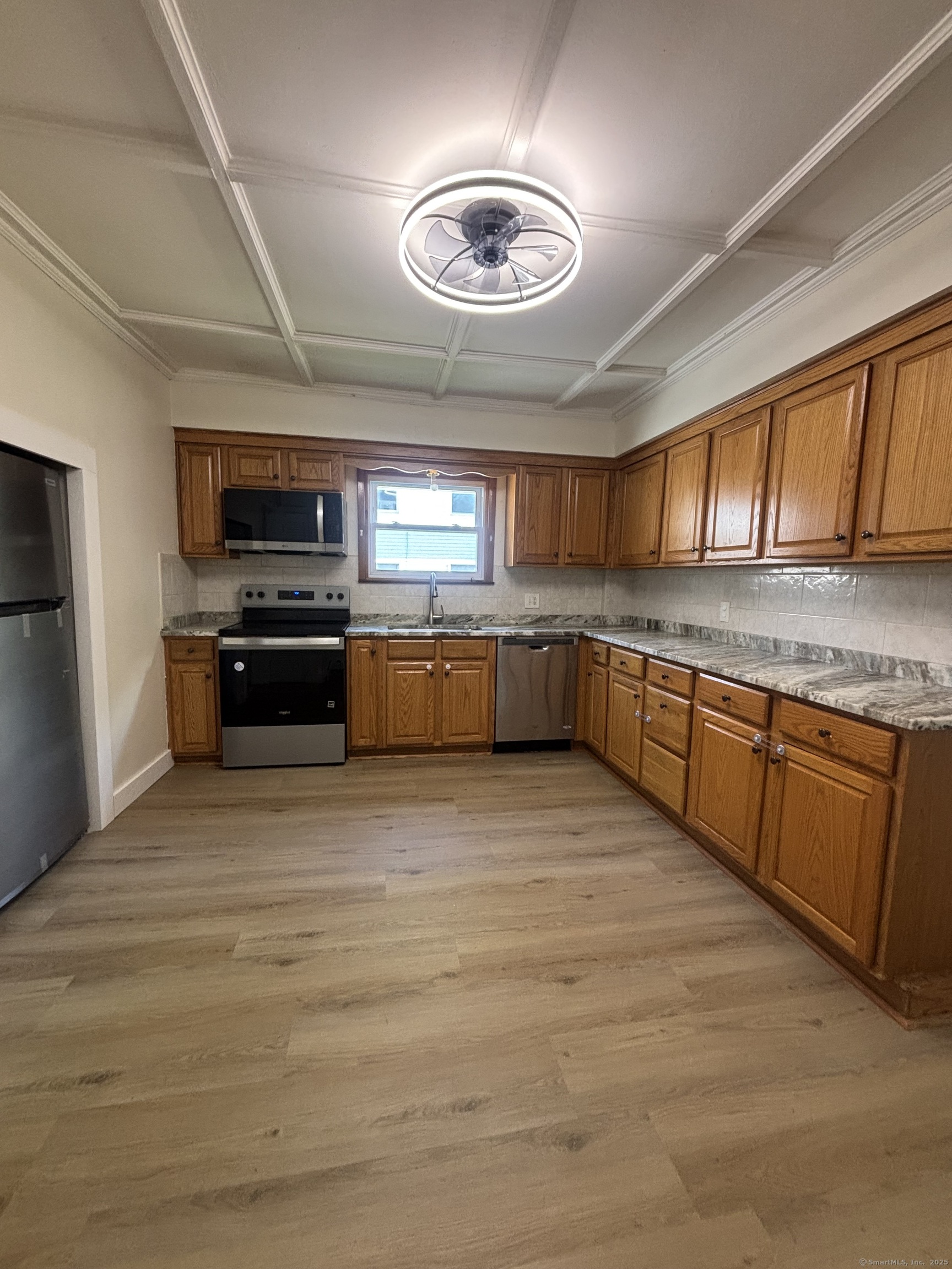 161 Cliff Street Norwich, CT 06360 - Photo 5 of 14 a large kitchen with stainless steel appliances granite countertop a stove sink and microwave