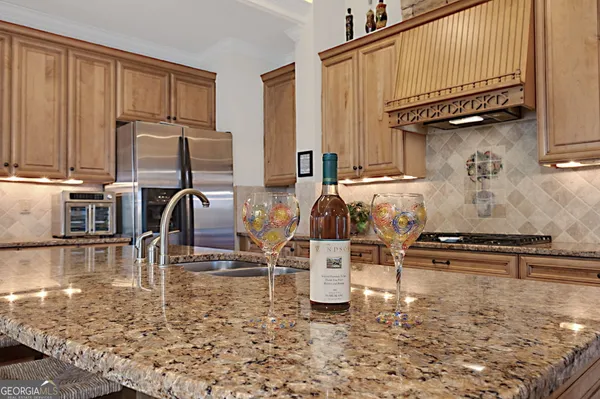 a kitchen with granite countertop stainless steel appliances and wooden cabinets