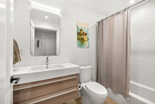 a bathroom with a sink a toilet and shower curtain