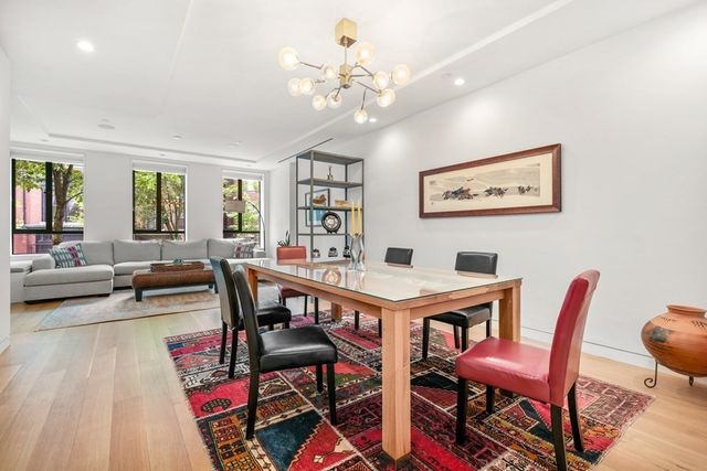a view of a dining room with furniture and a chandelier