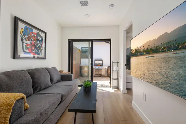 a living room with furniture and a floor to ceiling window