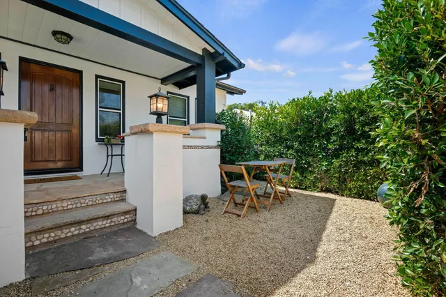 a view of a patio with table and chairs with wooden floor and fence
