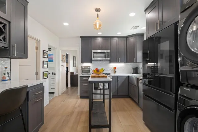 a kitchen with cabinets and wooden floor