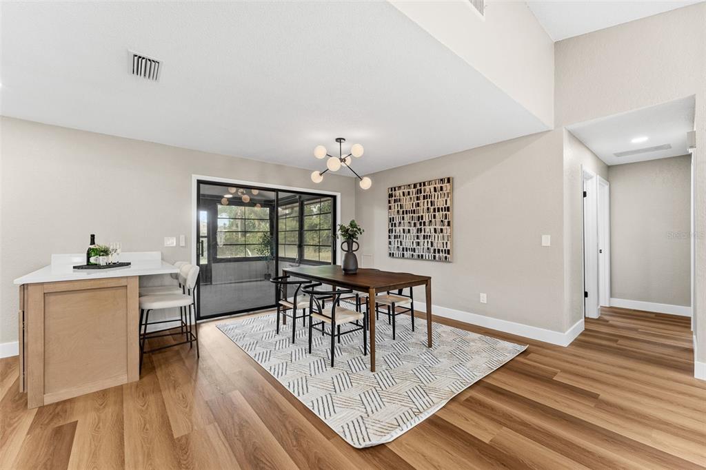 117 Poinciana Road Edgewater, FL 32141 - Photo 13 of 36 a view of a dining room with furniture and wooden floor