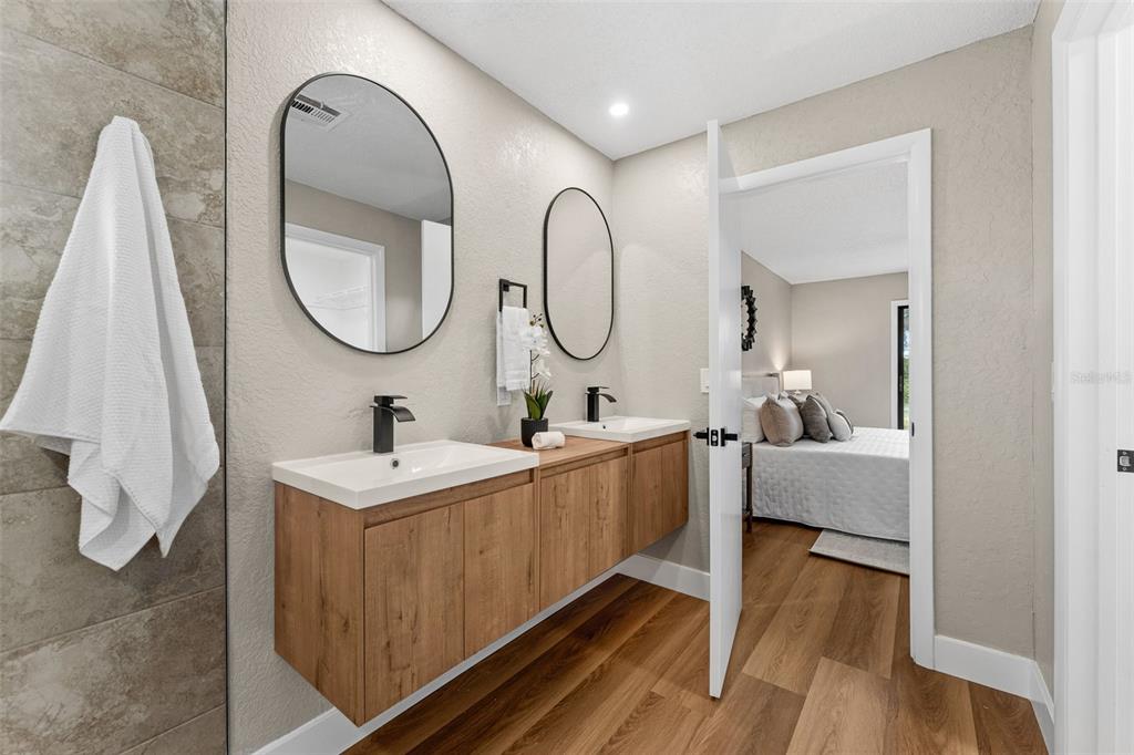 117 Poinciana Road Edgewater, FL 32141 - Photo 19 of 36 a bathroom with a double vanity sink and a mirror