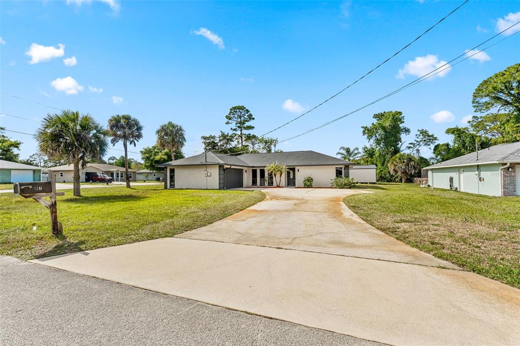 117 Poinciana Road Edgewater, FL 32141 - Photo 2 of 36 a front view of house with yard