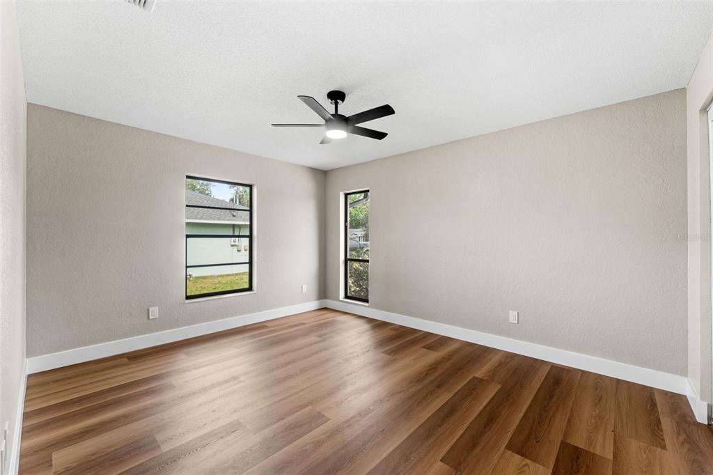 117 Poinciana Road Edgewater, FL 32141 - Photo 23 of 36 wooden floor in an empty room with a window