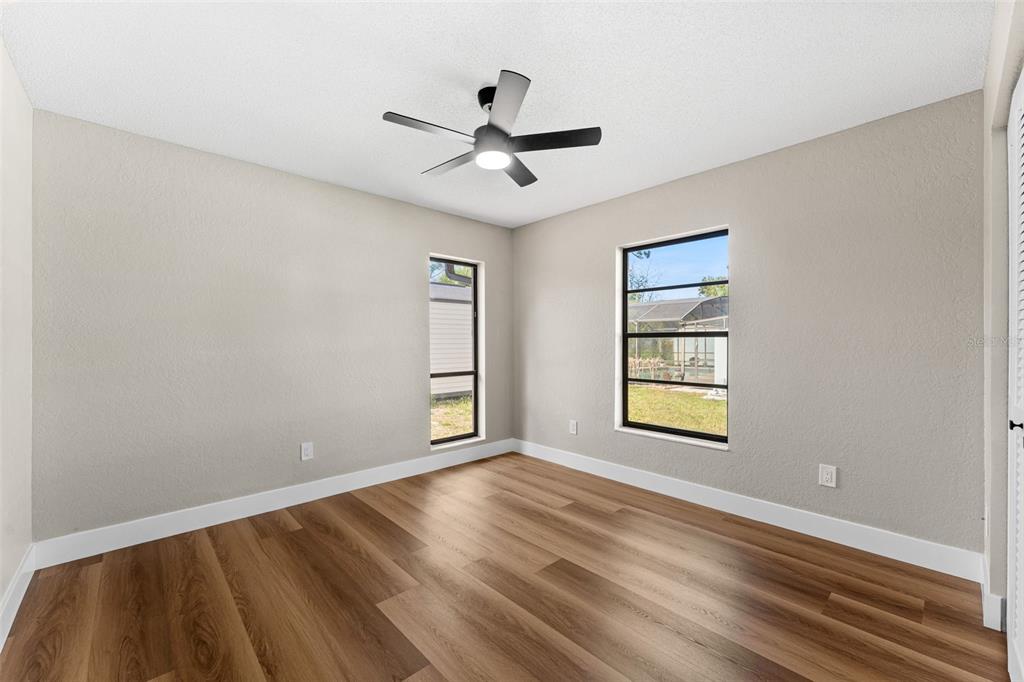 117 Poinciana Road Edgewater, FL 32141 - Photo 26 of 36 an empty room with windows and ceiling fan