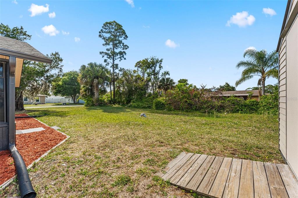 117 Poinciana Road Edgewater, FL 32141 - Photo 33 of 36 a view of a yard with an ocean view