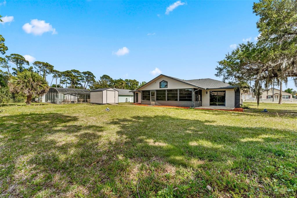 117 Poinciana Road Edgewater, FL 32141 - Photo 35 of 36 a front view of a house with a yard