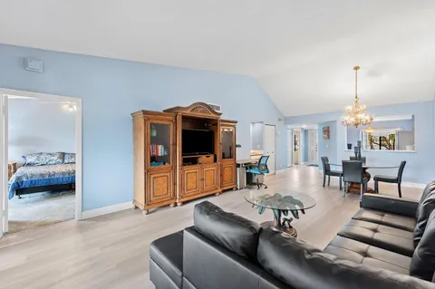 a living room with furniture and a floor to ceiling window